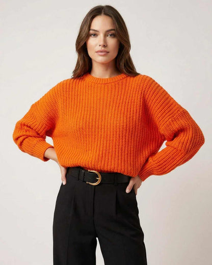 Sienna Sweater in bright orange knit texture with relaxed silhouette, paired with black trousers by RAMBLION.