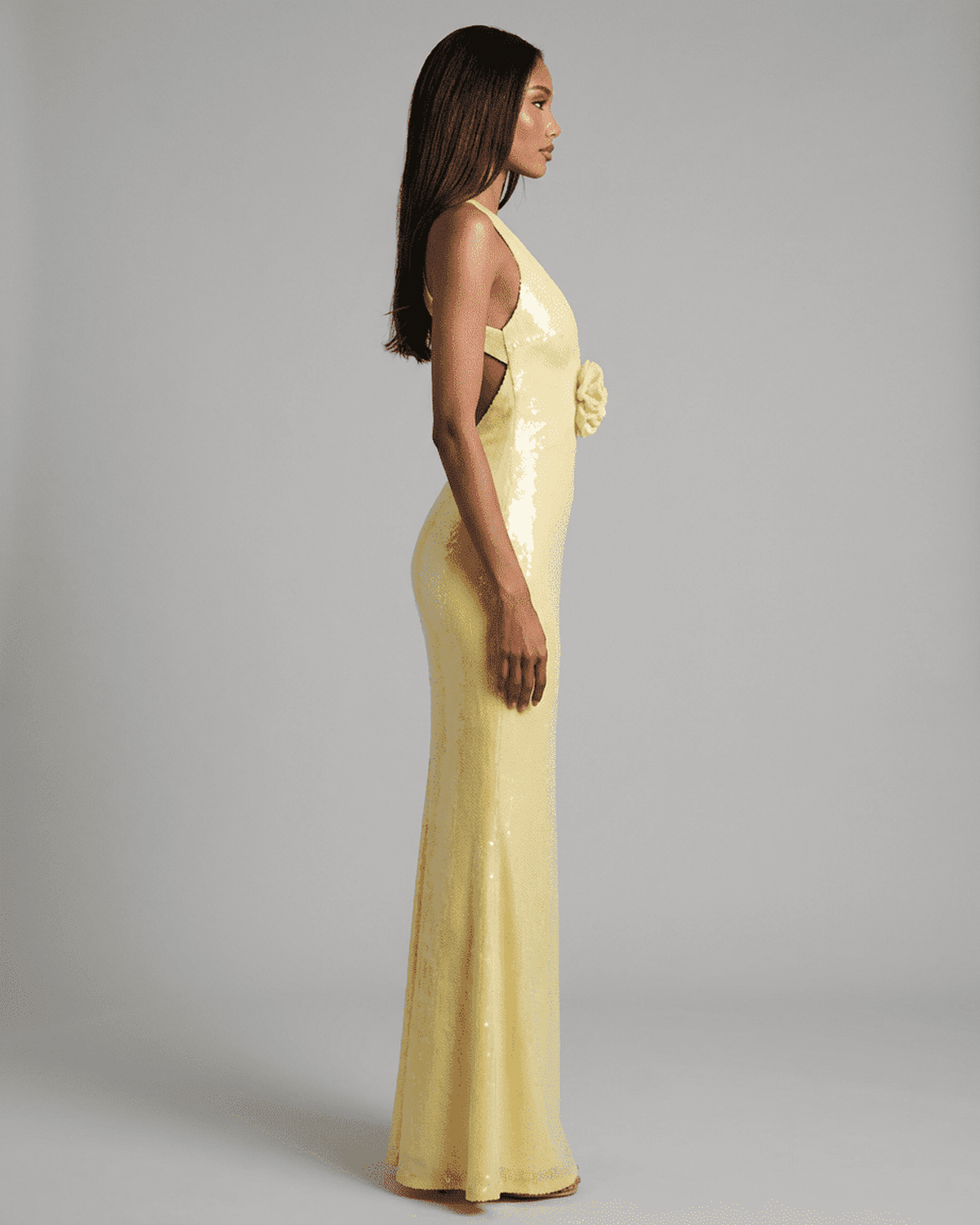 Solara Maxi Dress in yellow with backless design and floral sequin detail, showcasing a sleek silhouette.