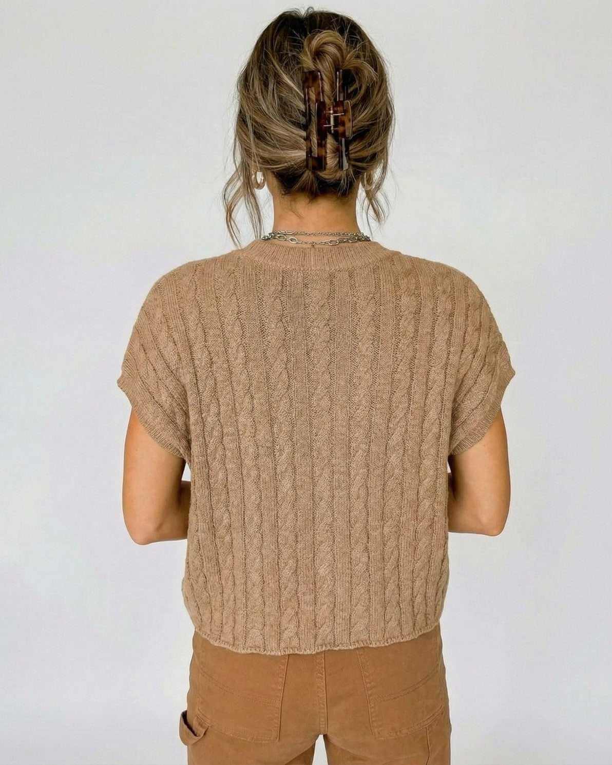 Back view of the Toscana Sweater, a short sleeve cable knit design by RAMBLION for relaxed elegance.