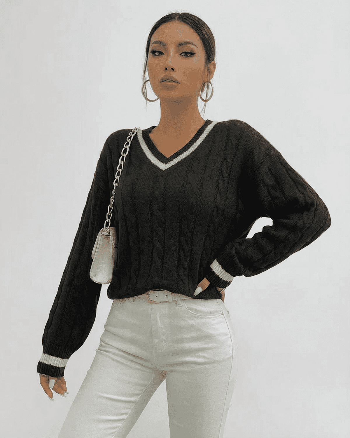 Verona Sweater in black cable knit with V-neck silhouette featuring RAMBLION branding.