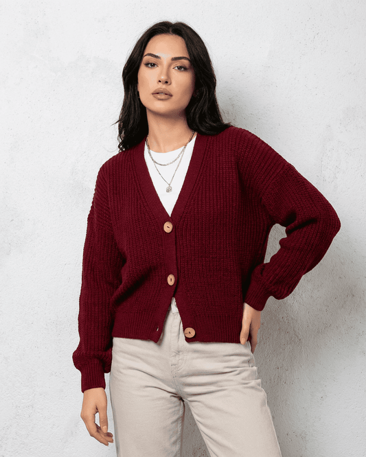 Vesper Cardigan in luxurious burgundy knitwear with V-neck design worn by a model.