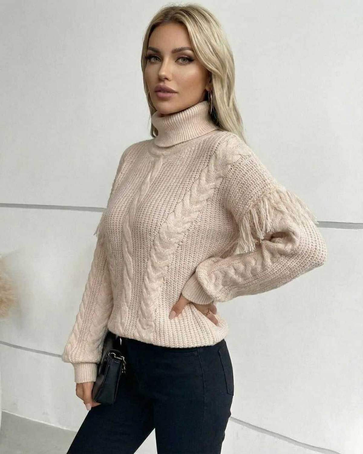 Vienna Sweater – Women’s Beige Turtleneck Sweater with cable knit and fringe details, perfect for fall and winter.
