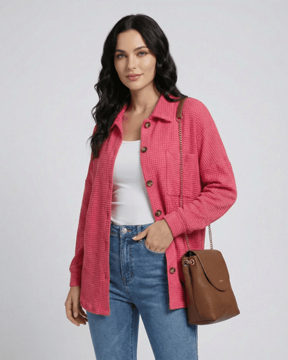Women wearing the Verona Jacket in pink waffle knit, styled with a casual outfit and handbag.