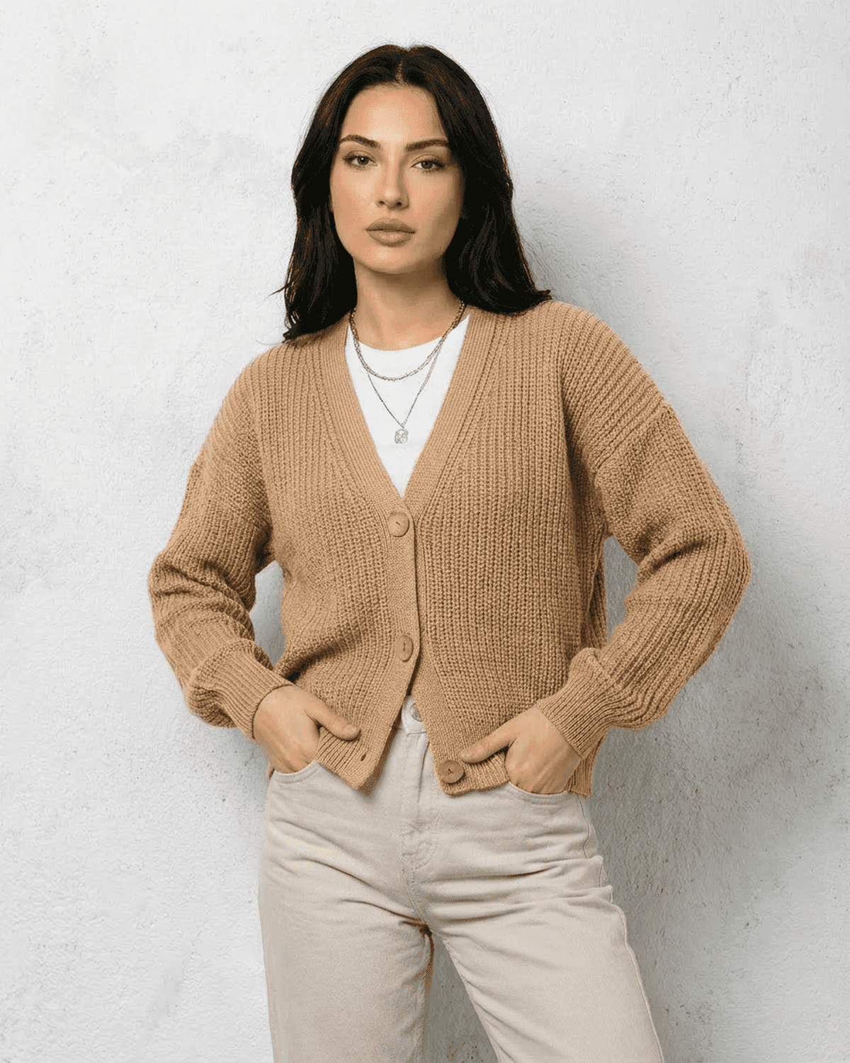 Saffron Cardigan in beige with V-neck and button front worn by a model for stylish and cozy layering.