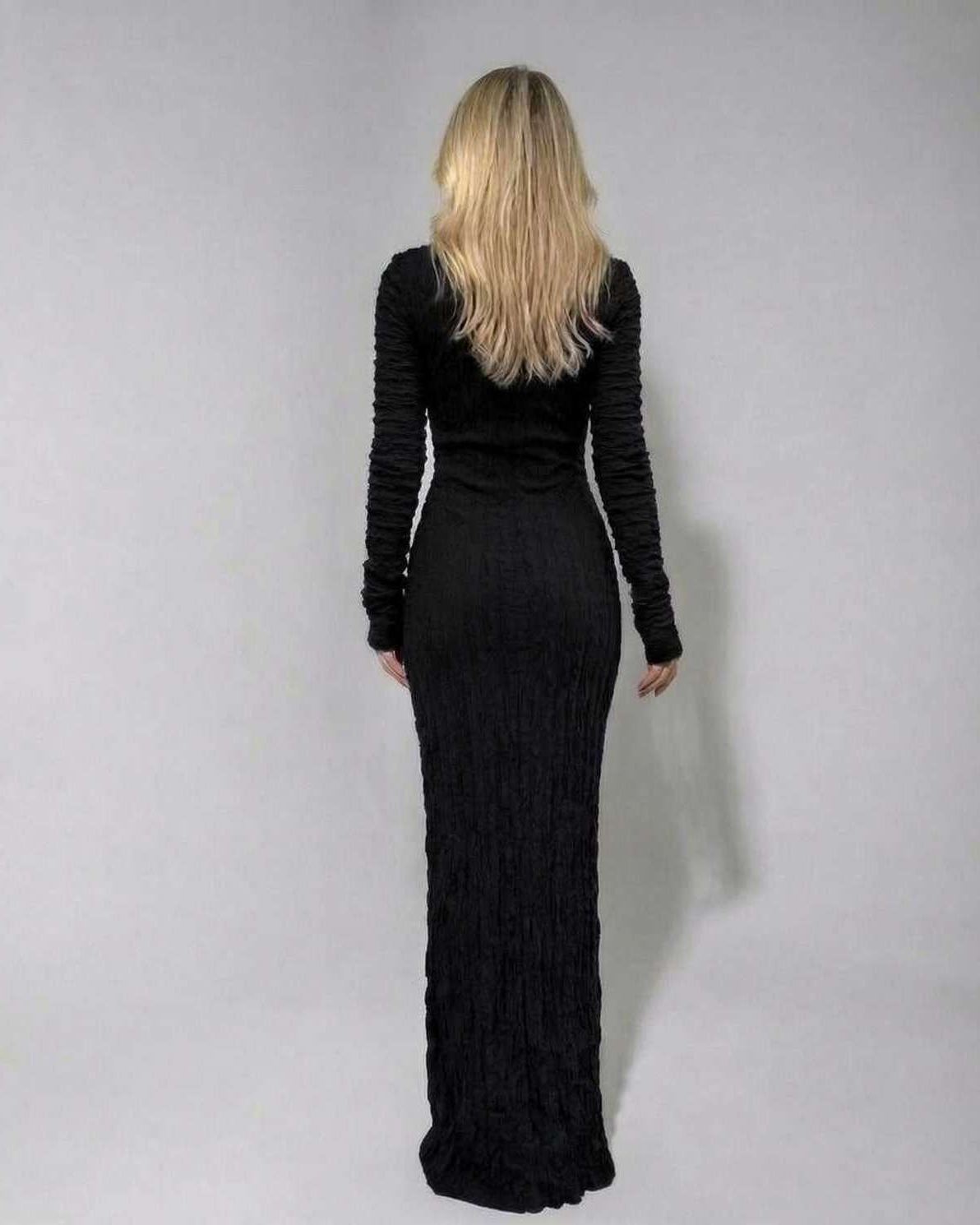 Sara Maxi Dress showcasing a black, ankle-length silhouette with textured finish, perfect for sophisticated evenings - RAMBLION.
