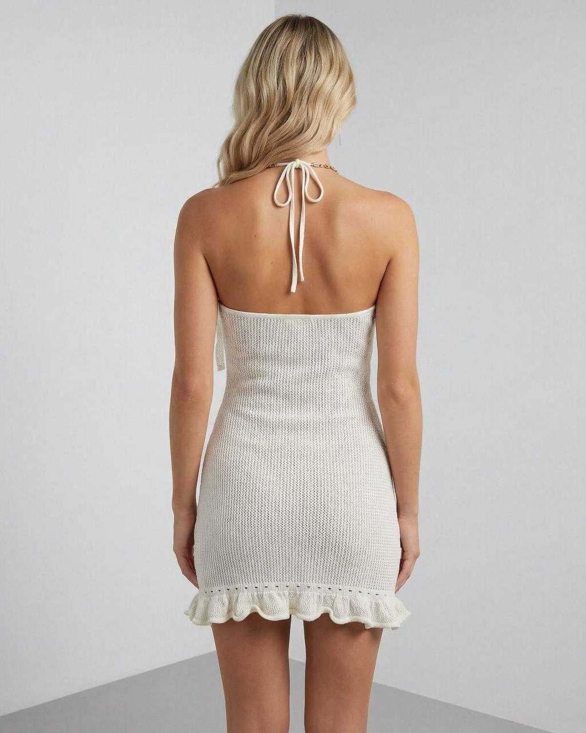 Tahe Mini Dress back view, white halter design with playful ruffles, perfect for summer occasions by RAMBLION.