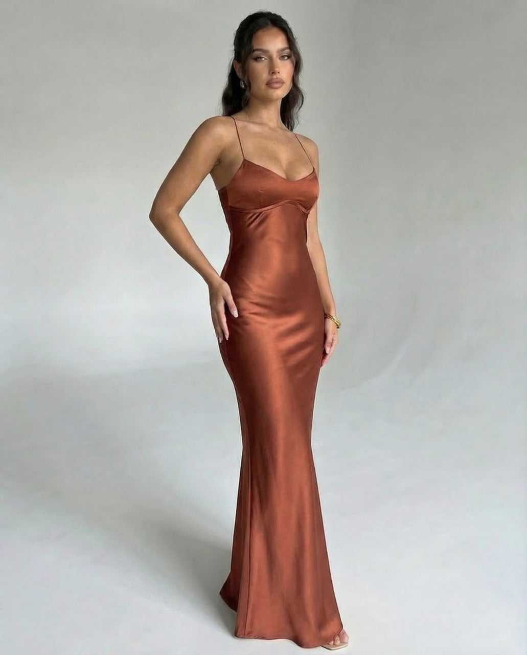 Tara Maxi Dress in luxurious brown satin, featuring V-neck and spaghetti straps, perfect for elegant occasions. RAMBLION.