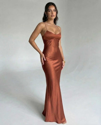 Tara Maxi Dress in luxurious brown satin, featuring V-neck and spaghetti straps, perfect for elegant occasions. RAMBLION.