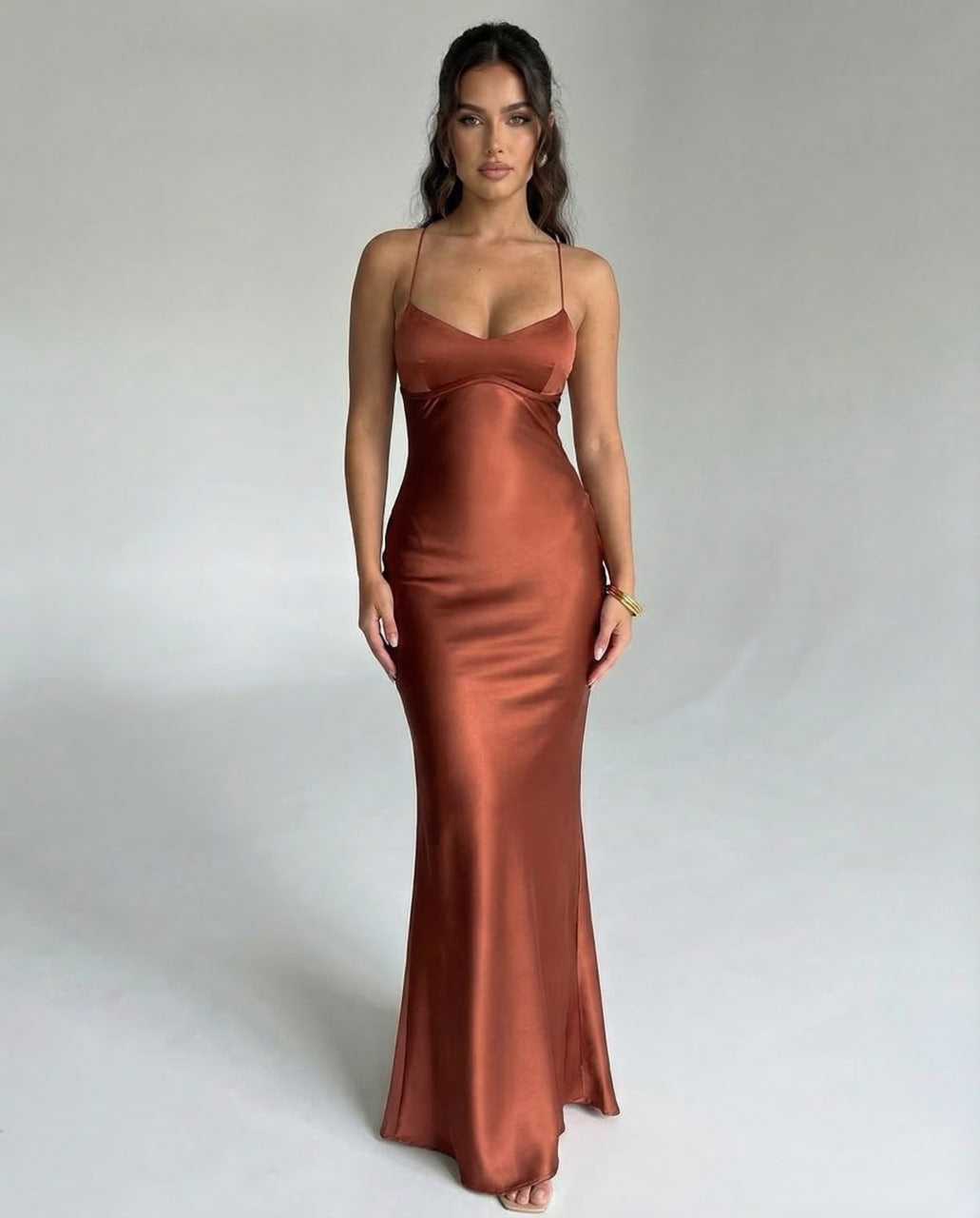 Tara Maxi Dress in rich brown satin, featuring a V-neckline and spaghetti straps, perfect for elegant occasions by RAMBLION.
