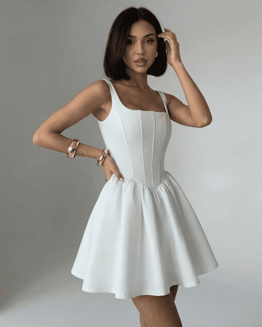 Model wearing Tara Mini Dress by RAMBLION, a chic white mini dress with a square neck, perfect for stylish occasions.