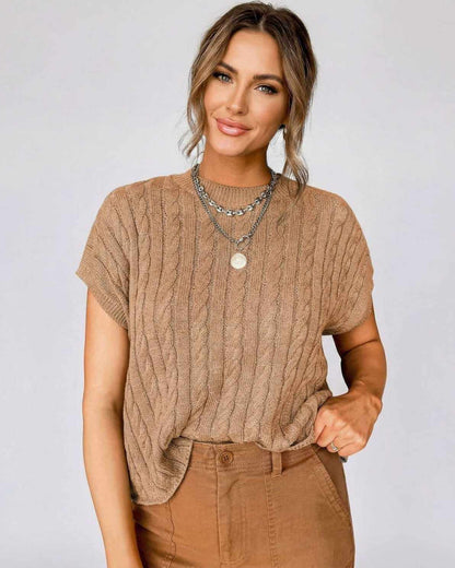 Toscana Sweater in cable knit design worn with relaxed style and layered necklaces, perfect for casual or elevated looks.