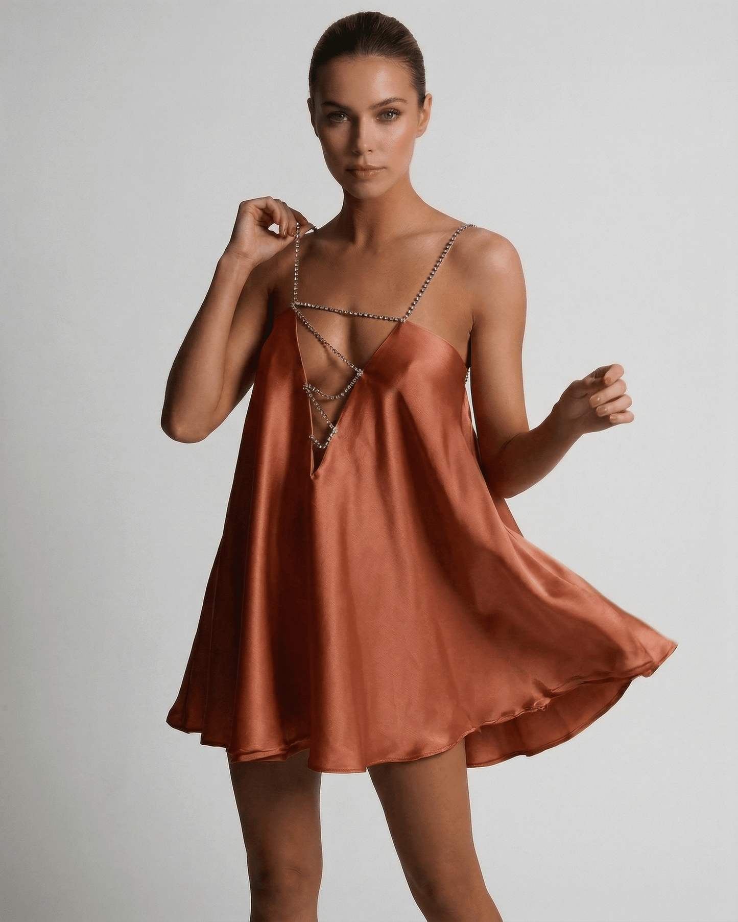 Uma Mini Dress by RAMBLION in vibrant orange satin with rhinestone straps, perfect for stylish occasions.