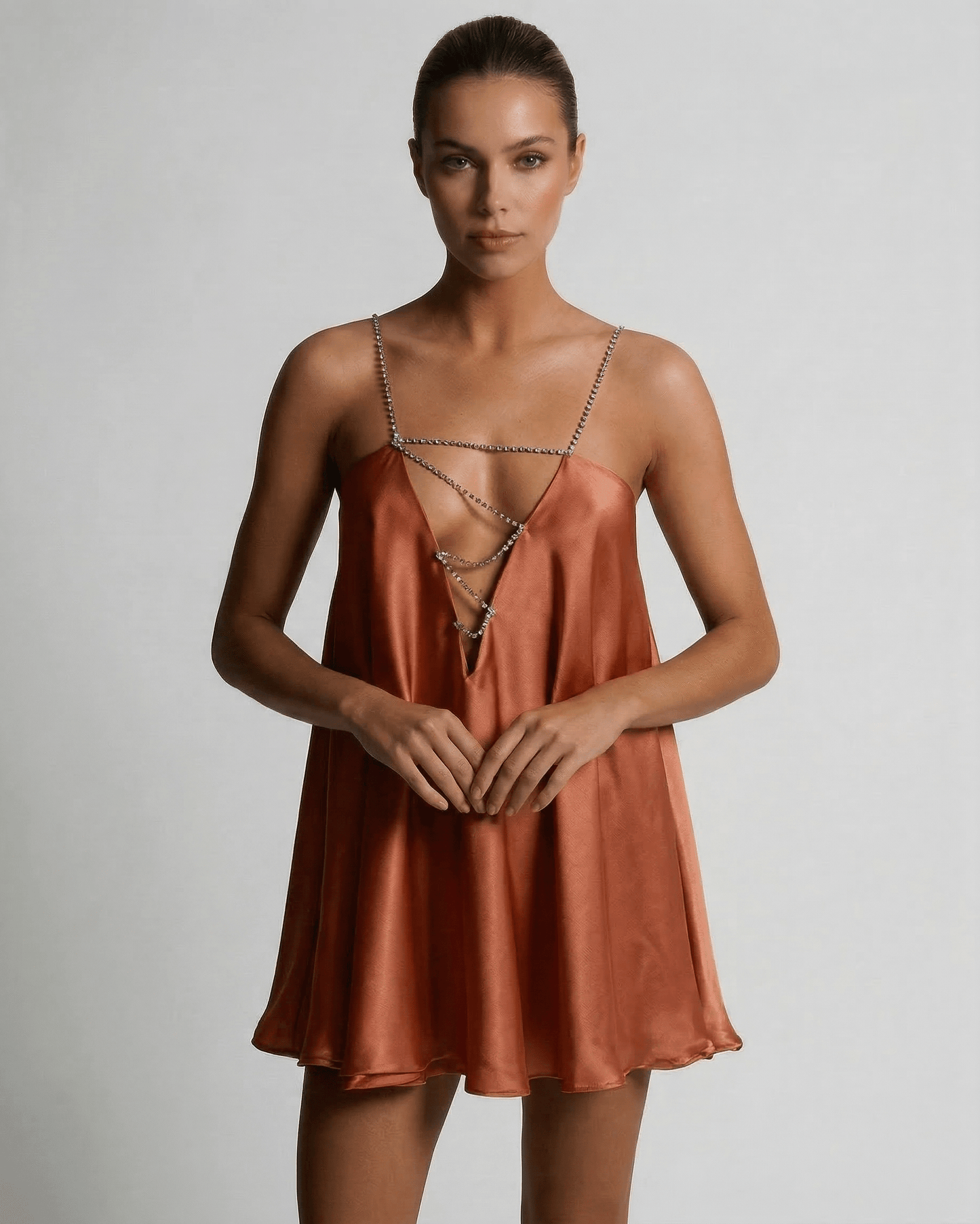 Uma Mini Dress by RAMBLION, vibrant orange satin, V neck, rhinestone straps, luxurious feel, ideal for special occasions.