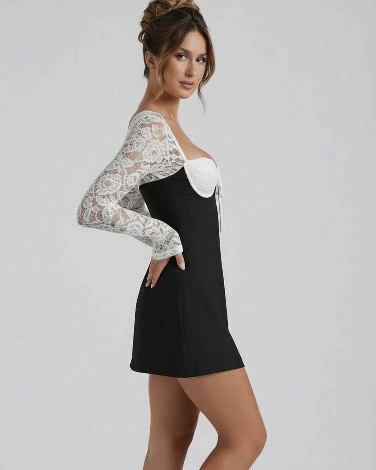 Vafy Mini Dress featuring a black body with delicate white lace sleeves, perfect for chic occasions by RAMBLION.
