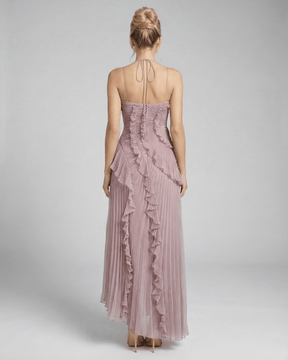 Wana Maxi Dress featuring a halter neck and ruffle accents in soft pink, perfect for elegant occasions. RAMBLION brand.