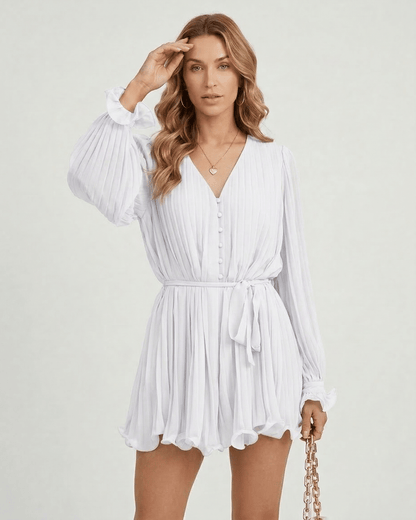Yona Mini Dress by RAMBLION in white, featuring V-neck, pleats, and lightweight fabric, perfect for a summer outing.