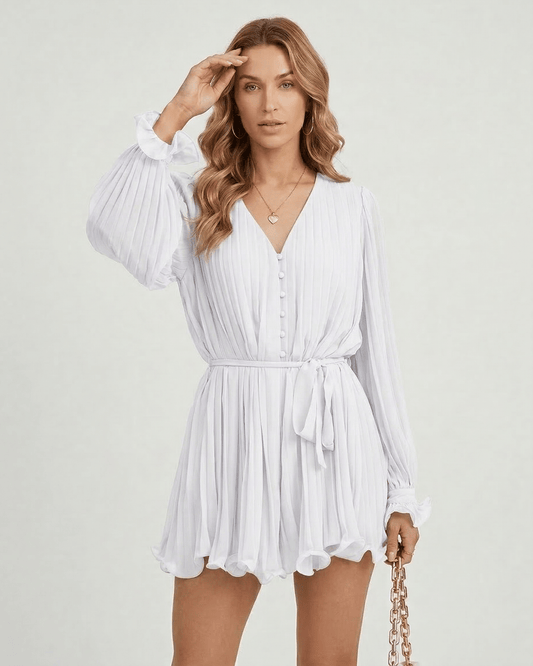 Yona Mini Dress by RAMBLION in white, featuring V-neck, pleats, and lightweight fabric, perfect for a summer outing.