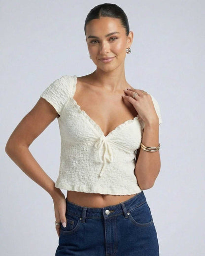 Zema Top by RAMBLION, white crop top with a V-neck, soft texture, perfect for casual outings.